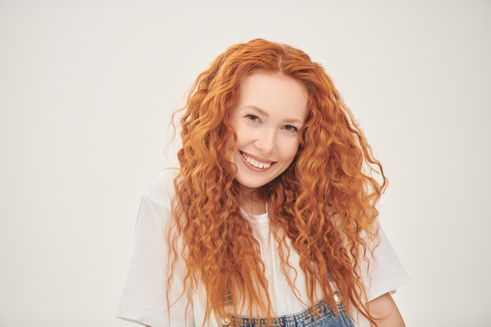 A portrait of a woman with curly red hair